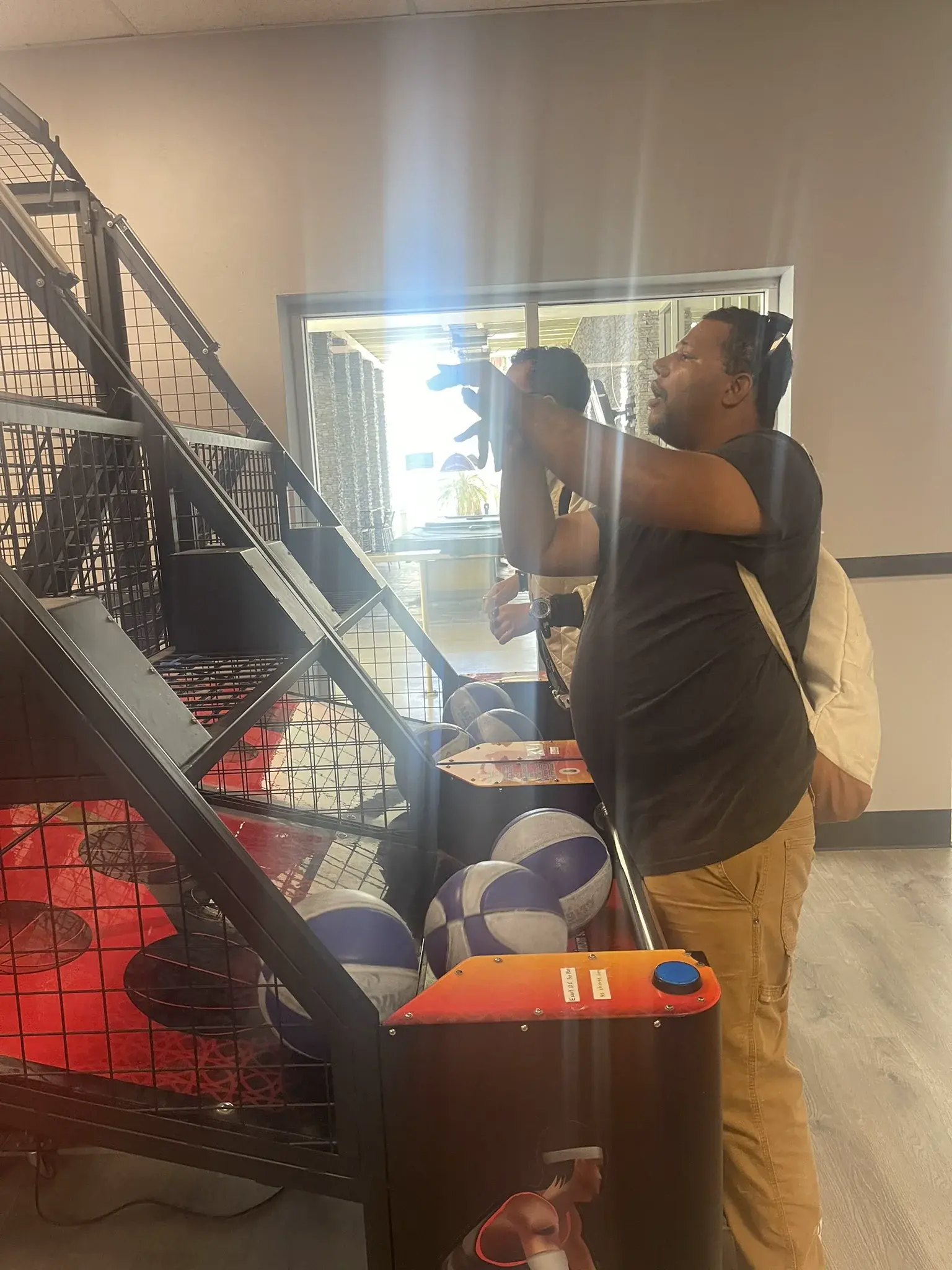 Participants enjoying an arcade game during a day program outing